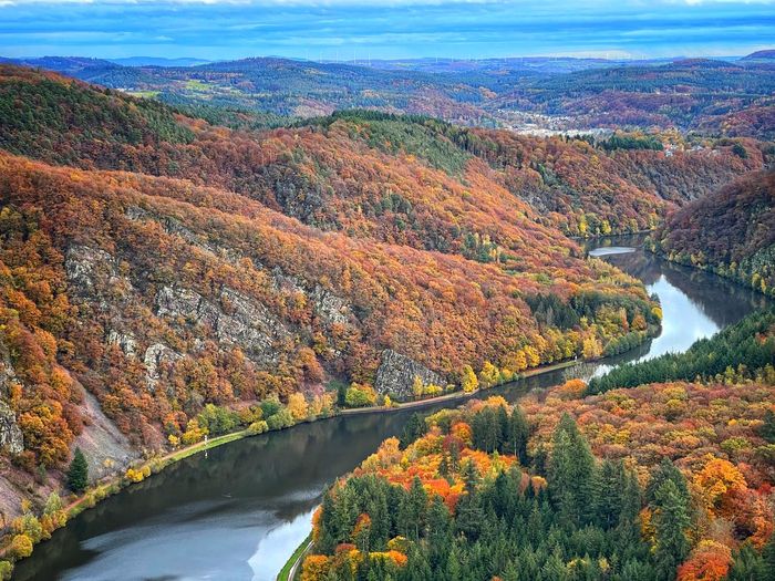 Scenic view of river against sky during autumn
