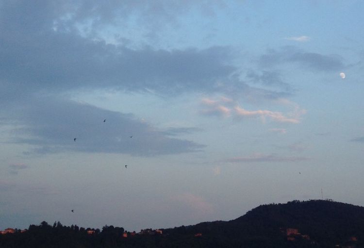 Scenic view of mountains against cloudy sky