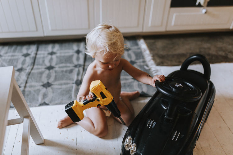 Toddler boy playing with toy drill