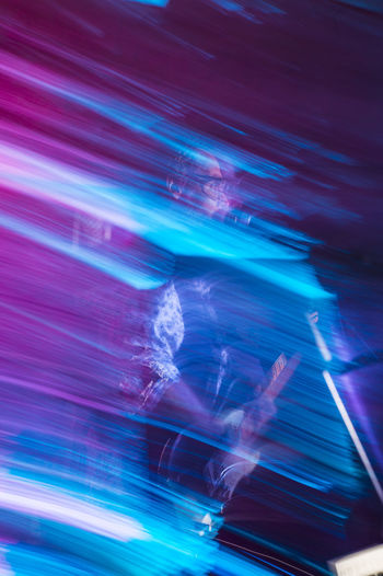 Blurred scene of singer performing with an electric guitar on stage