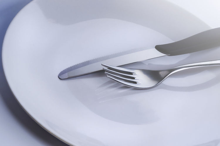 High angle view of fork in plate on table