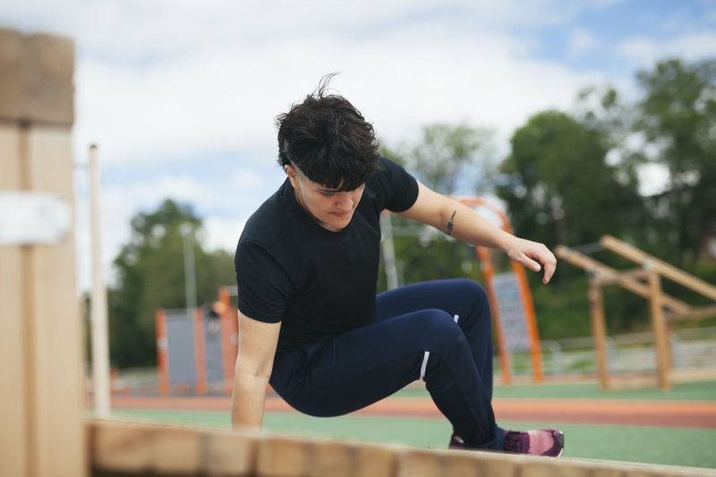 Young woman exercising at outdoor gym