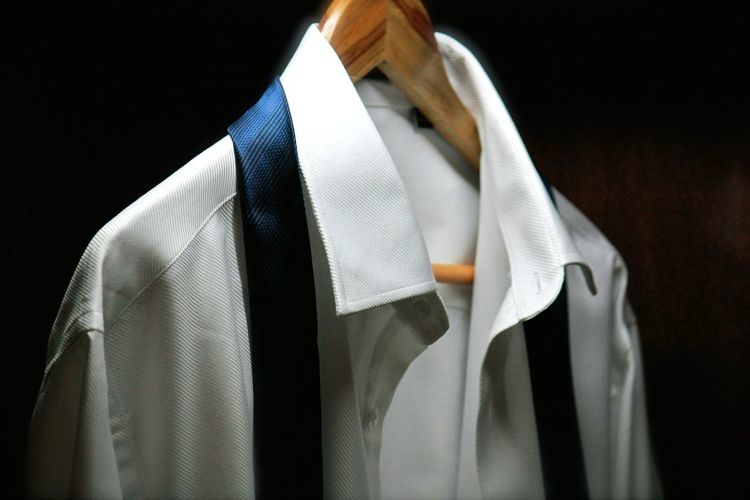 Close-up of clothes hanging on black background