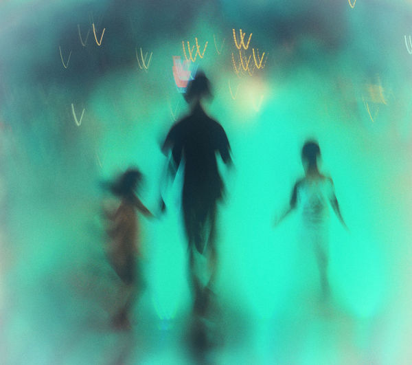 Silhouette people dancing in sea