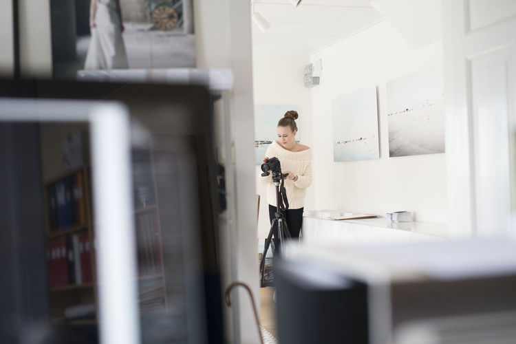 Woman photographing at home