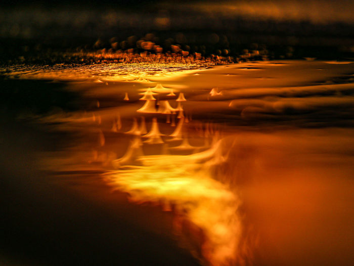 Close-up of illuminated water at sunset