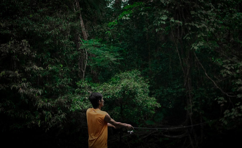 Rear view man standing in forest