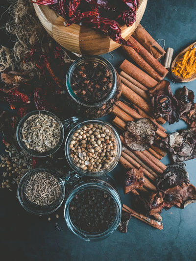 High angle view of spices and herbs on a black background 