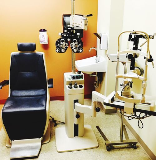 Empty chair with eye test equipment at clinic