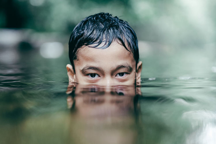 Portrait of boy an swimming in river