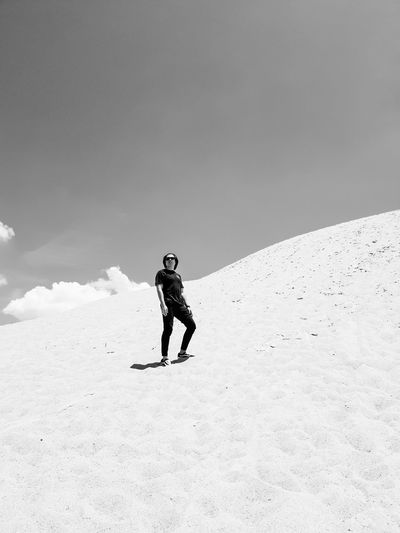 Full length of person on sand mountain against sky