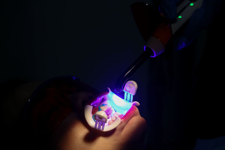 Close-up of hand holding multi colored lights