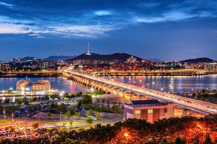 High angle view of city lit up at night