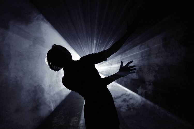 Silhouette woman dancing in nightclub