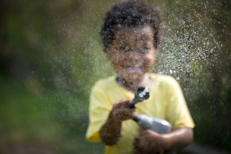 Portrait of young man standing in water