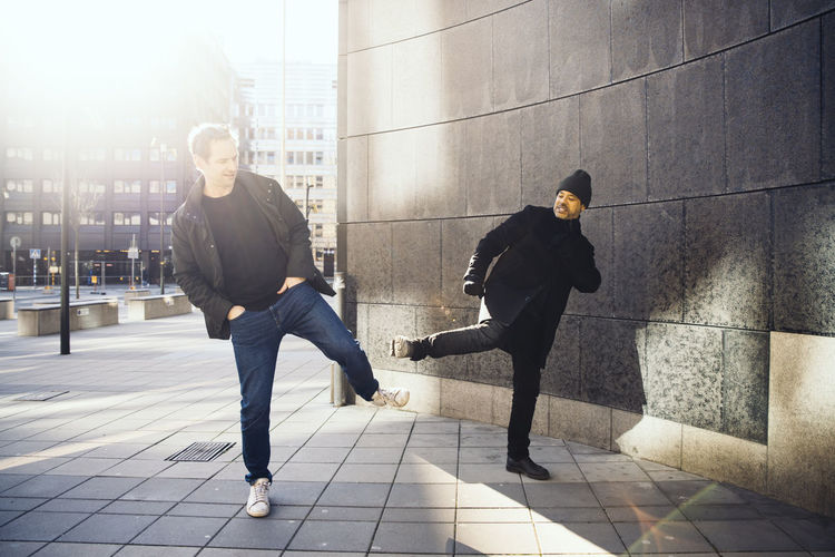 Two people greeting using feet