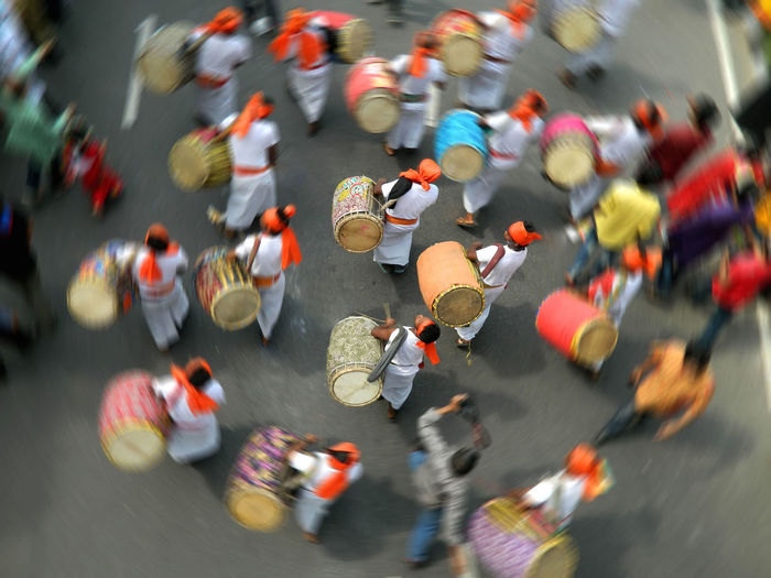 High angle view of men with drums walking on street
