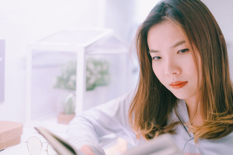 Portrait of beautiful young woman sitting at home