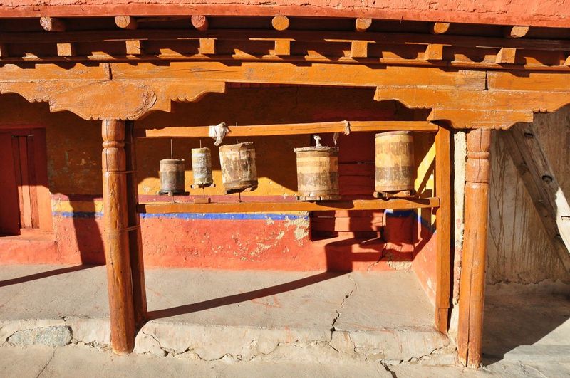 Prayer wheels in temple on sunny day