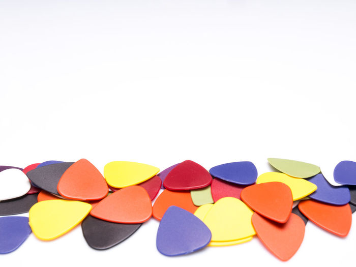 Close-up of colorful guitar picks over white background
