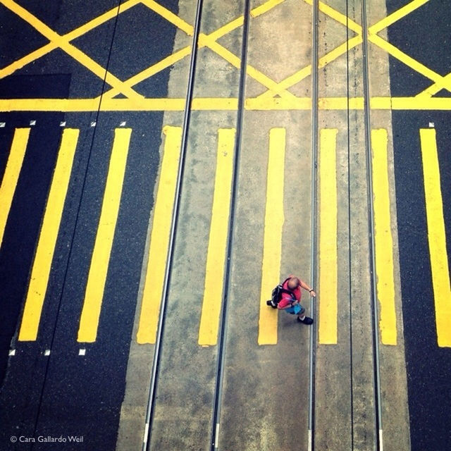 High angle view of man crossing street