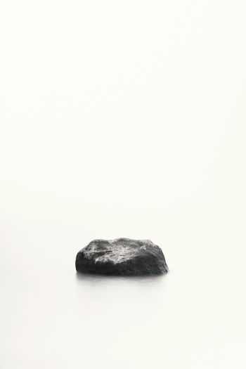 Close-up of rock over white background