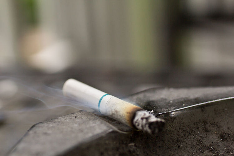 Close-up of burning cigarette on ashtray