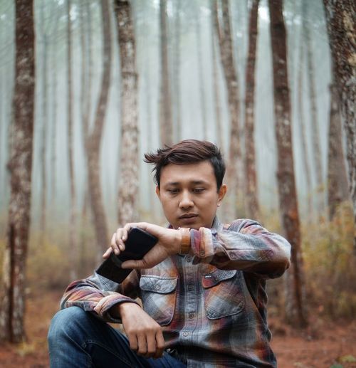 Portrait of young man sitting outdoors