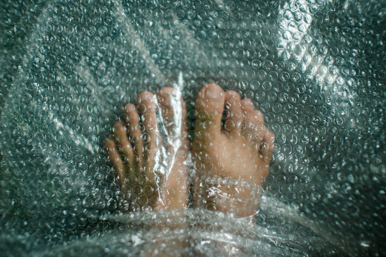 Close-up of legs under bubble wrap