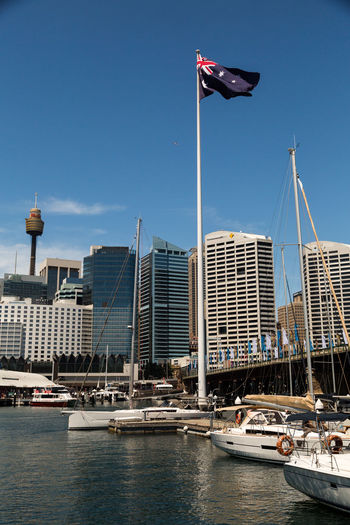 Low angle view of australian flag against sky at harbor in city