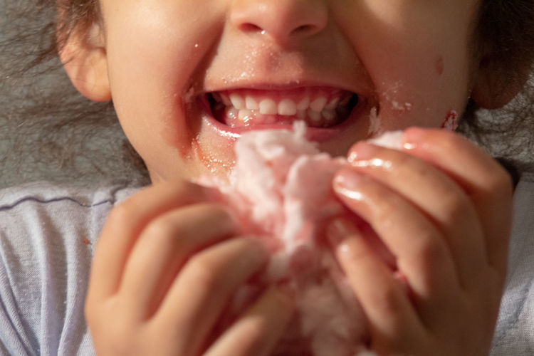 Close-up of girl eating cotton candy