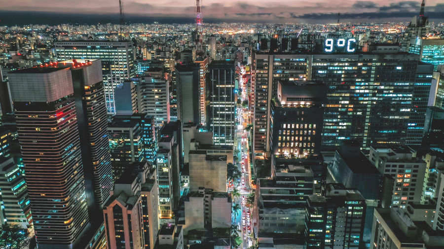 Aerial view of illuminated buildings in city at night