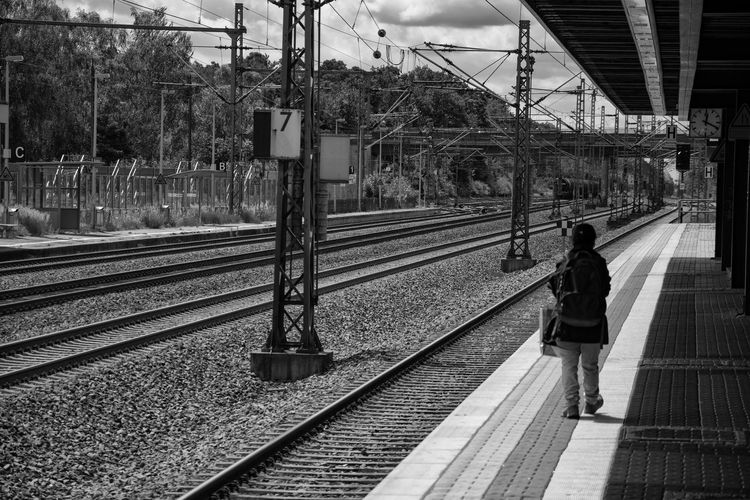 Rear view of commuter walking on railroad platform