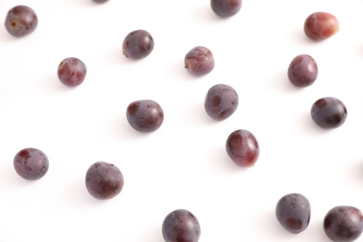 High angle view of coffee beans over white background