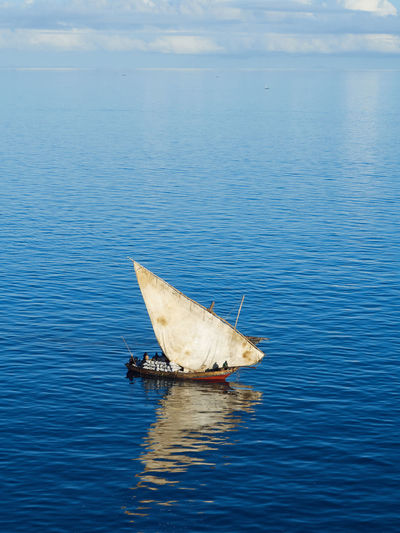 Traditional african sailing boat in open sea during the day.