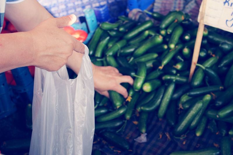 Midsection of woman holding food at market stall