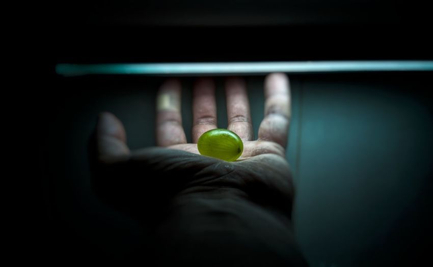 Digital composite image of hand holding ball
