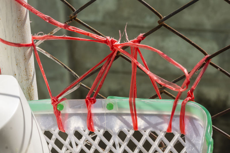 Close-up of rope tied to chainlink fence
