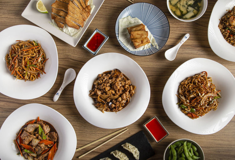 Assorted chinese food. famous dishes of chinese cuisine on the table. top view.