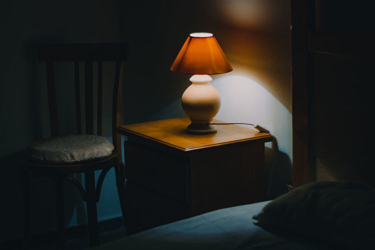 Illuminated electric lamp on table