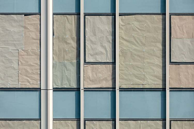 Beautiful texture of glass windows of condominium with crumple paper attachment for sun blocking