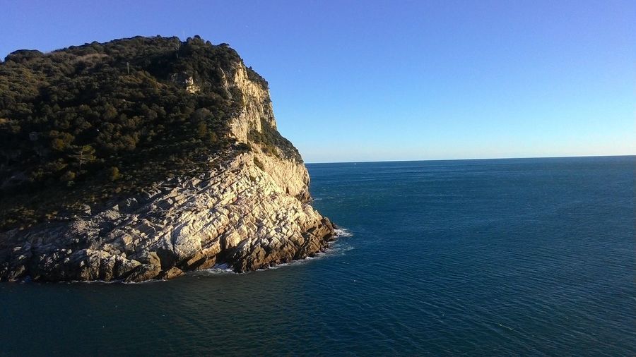 Scenic view of sea against clear blue sky