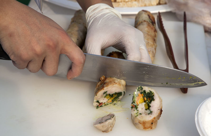 Midsection of chef slicing food