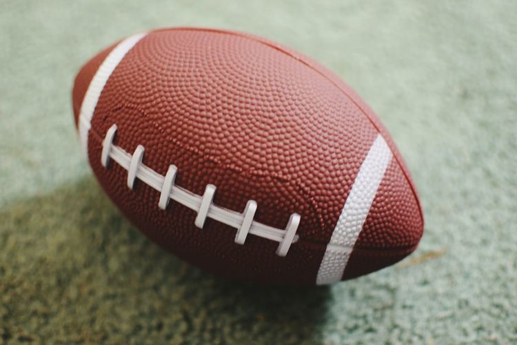 Close-up of american football on field