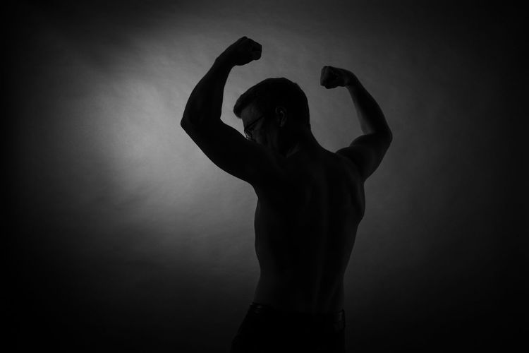 Silhouette woman standing against black background