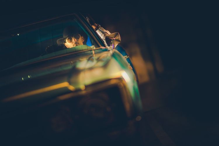 Man driving vintage car at night