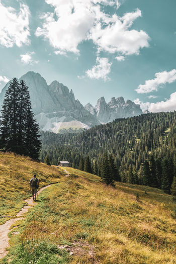 Mountain hikers in the dolomites, italy. odle mountain peaks.