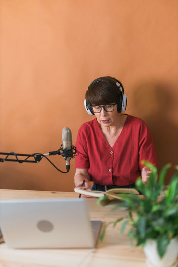 Senior woman podcasting in studio
