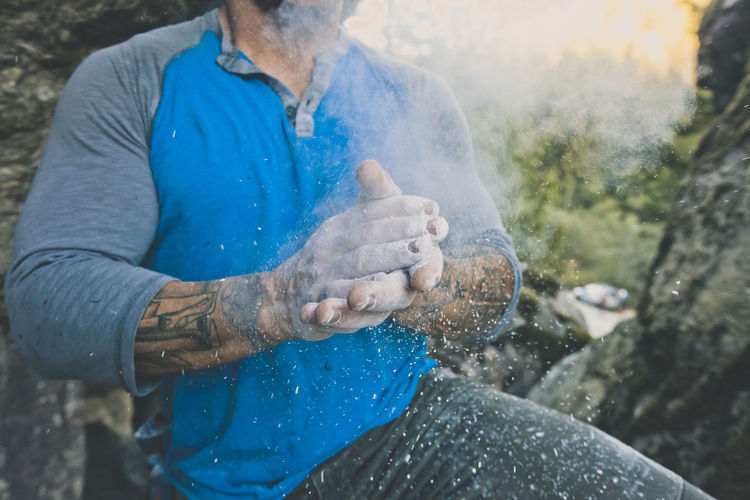 Midsection of man with chalk standing on mountain