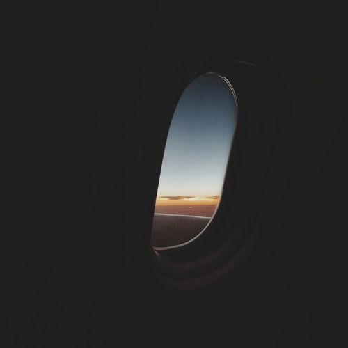 Close-up of silhouette airplane window